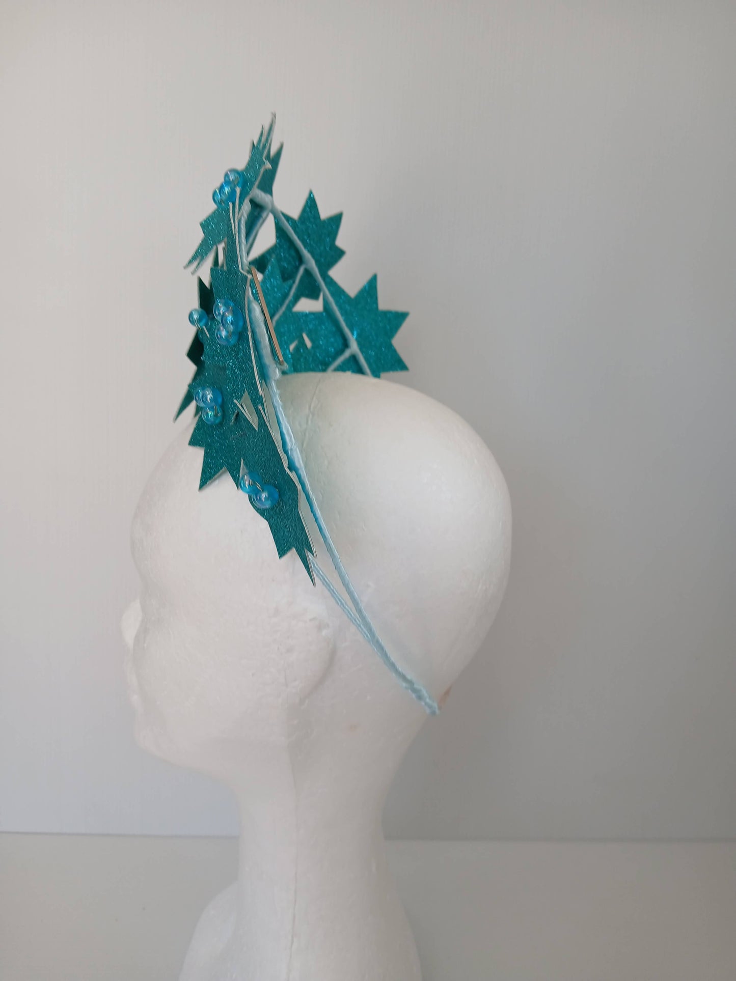 A picture of a Green Pleather Millinery Crown by Melissa Rath Millinery