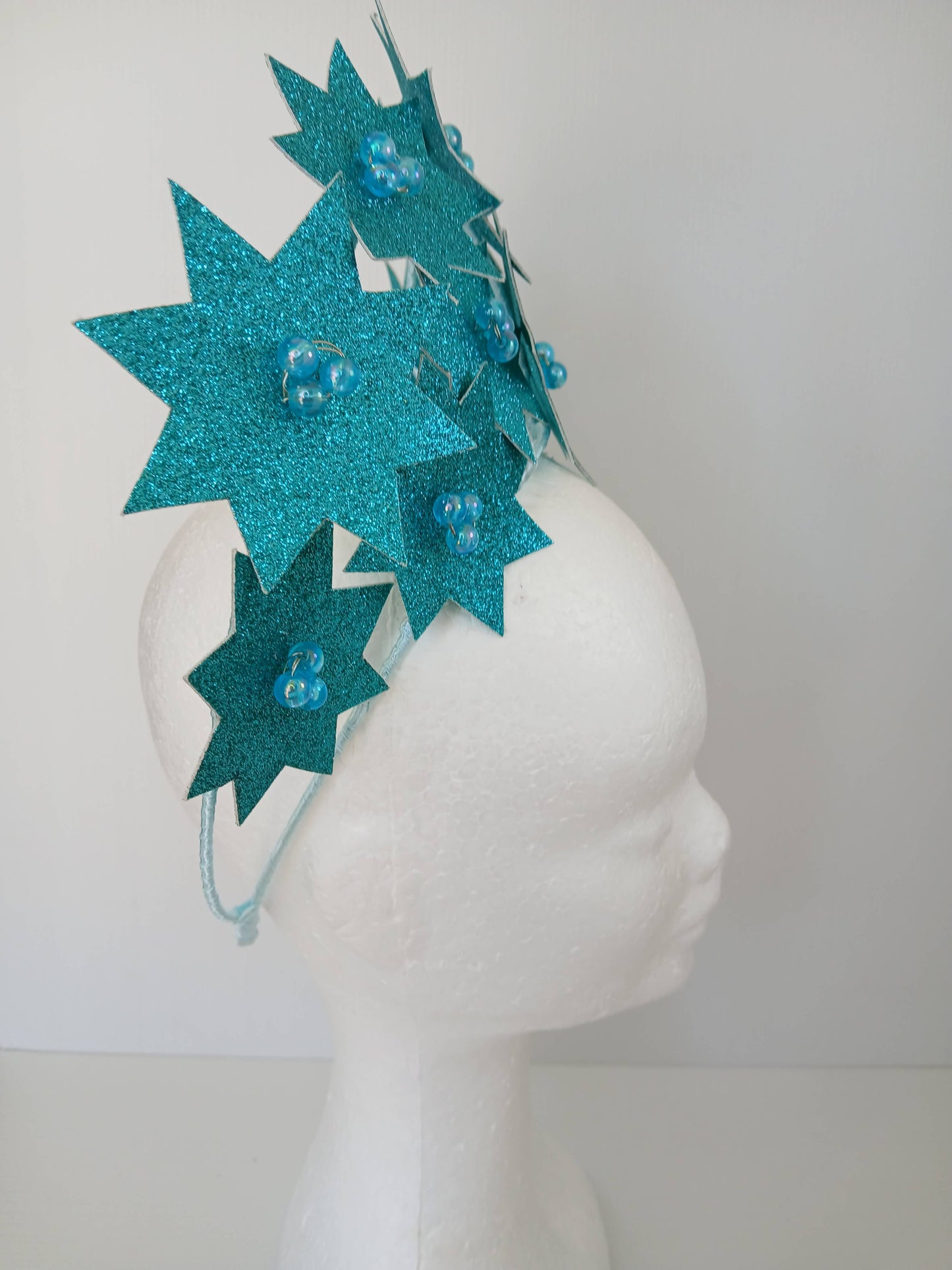 A picture of a Green Pleather Millinery Crown by Melissa Rath Millinery