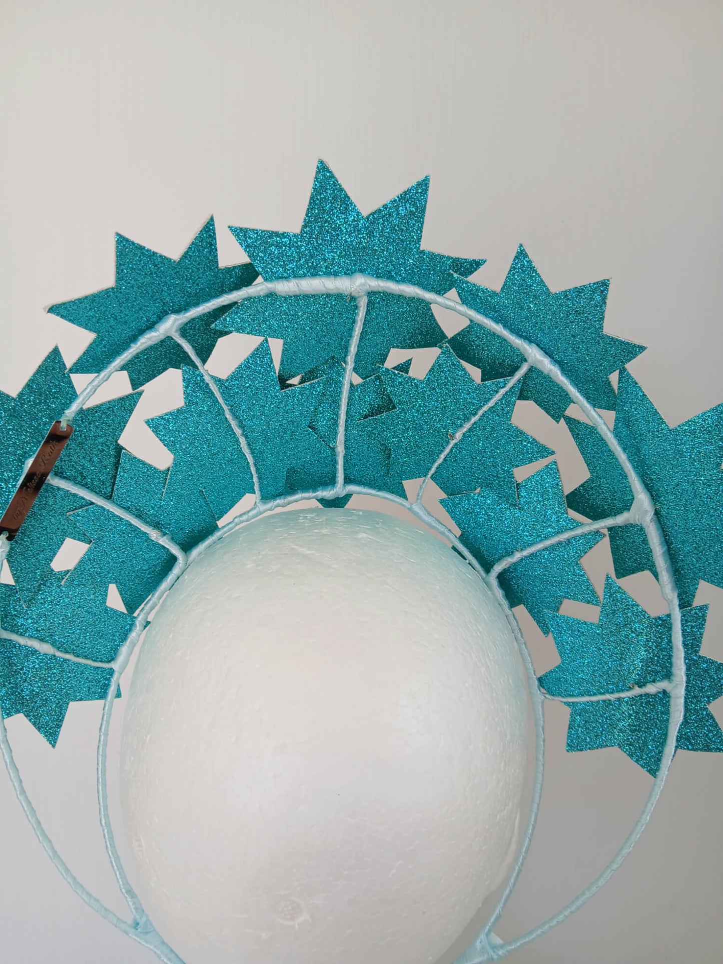 A picture of a Green Pleather Millinery Crown by Melissa Rath Millinery.