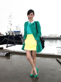 A picture of a woman wearing an outfit in a green analogous colour scheme.
