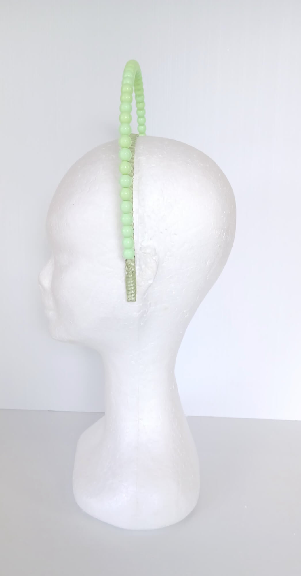 A picture of a Green Beaded Headband by Melissa Rath Millinery