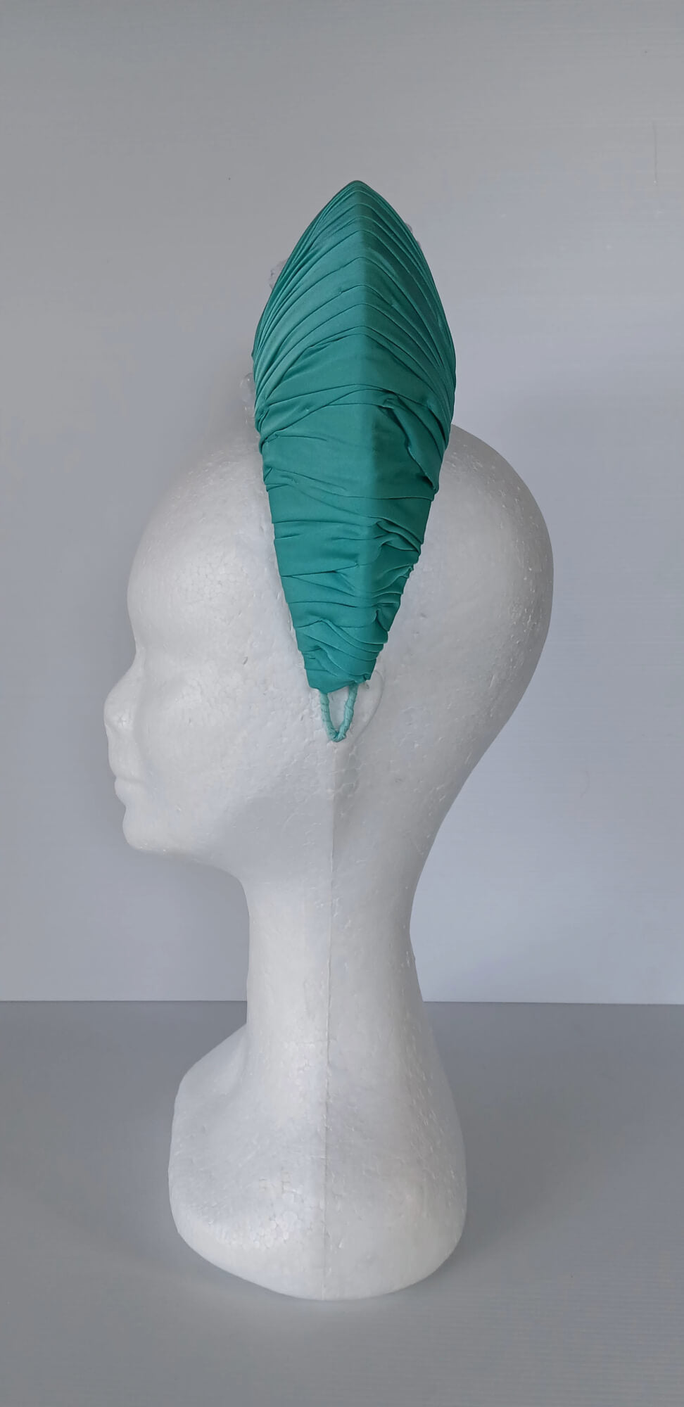 A picture of a Green Blocked Millinery Crown by Melissa Rath Millinery.