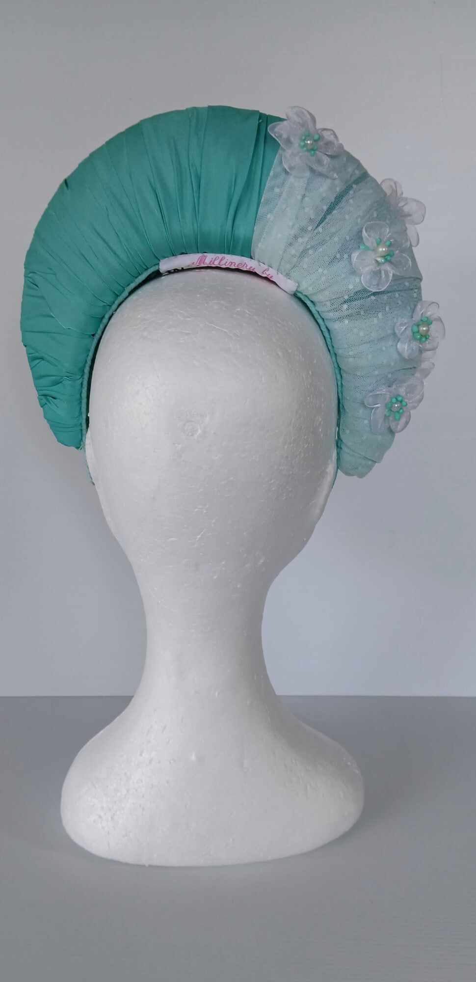 A picture of a Green Blocked Millinery Crown by Melissa Rath Millinery.