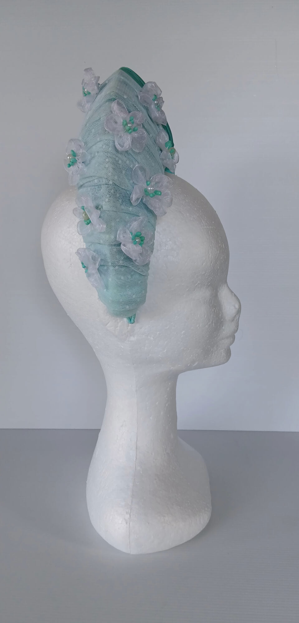 A picture of a Green Blocked Millinery Crown by Melissa Rath Millinery.