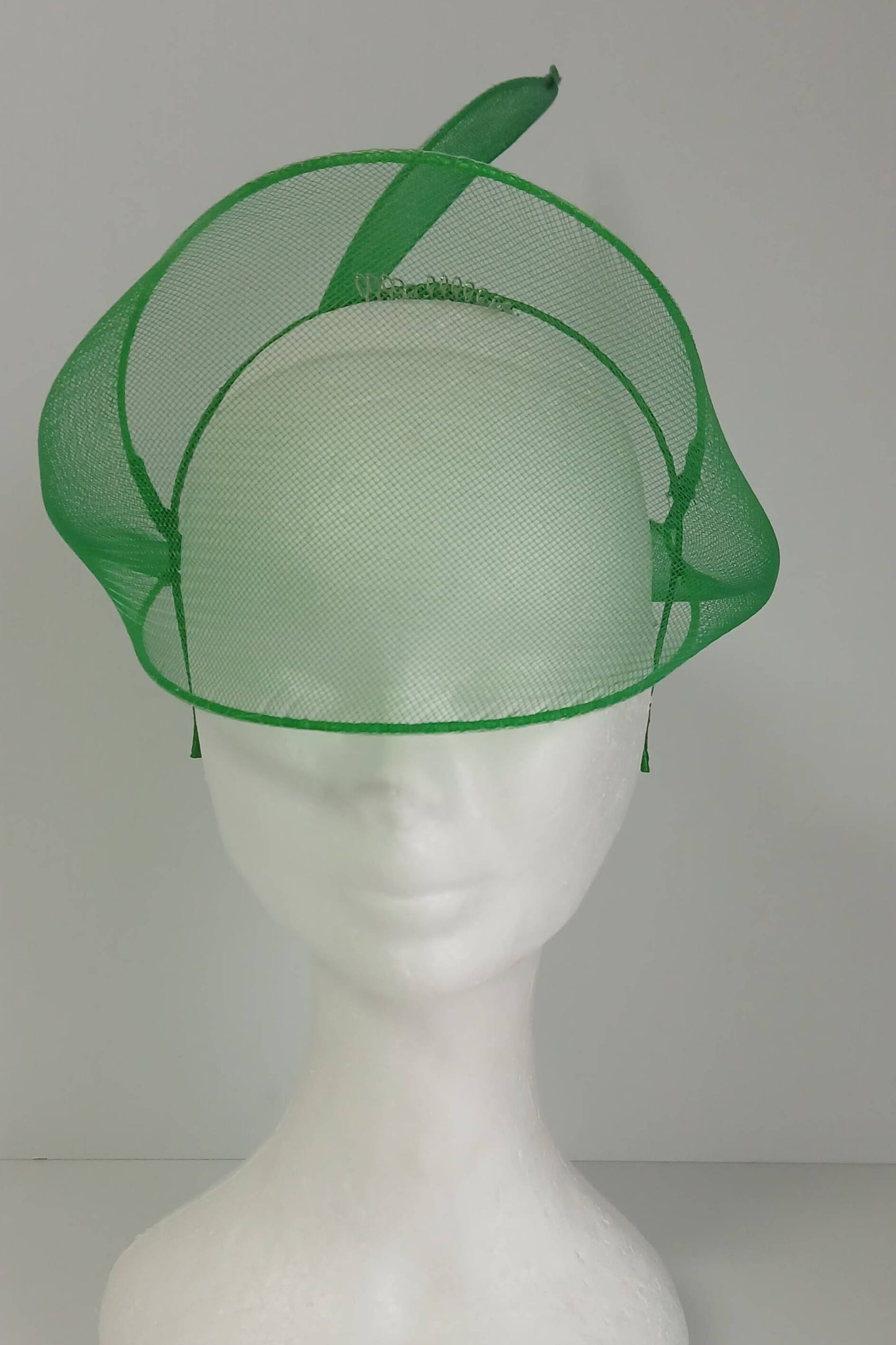 A picture of a green crinoline veil with Swirls by Melissa Rath Millinery