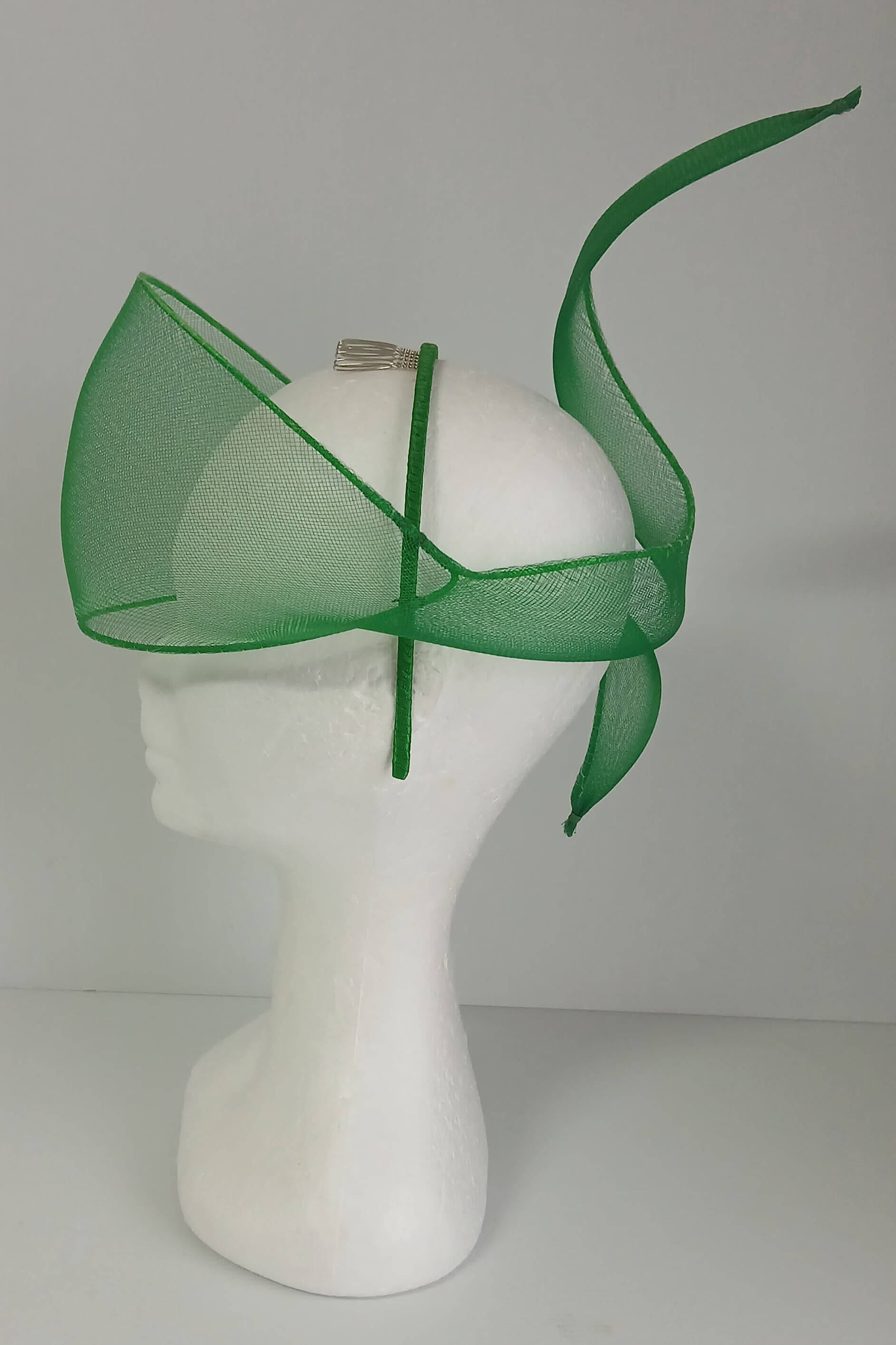 A picture of a green crinoline veil with Swirls by Melissa Rath Millinery