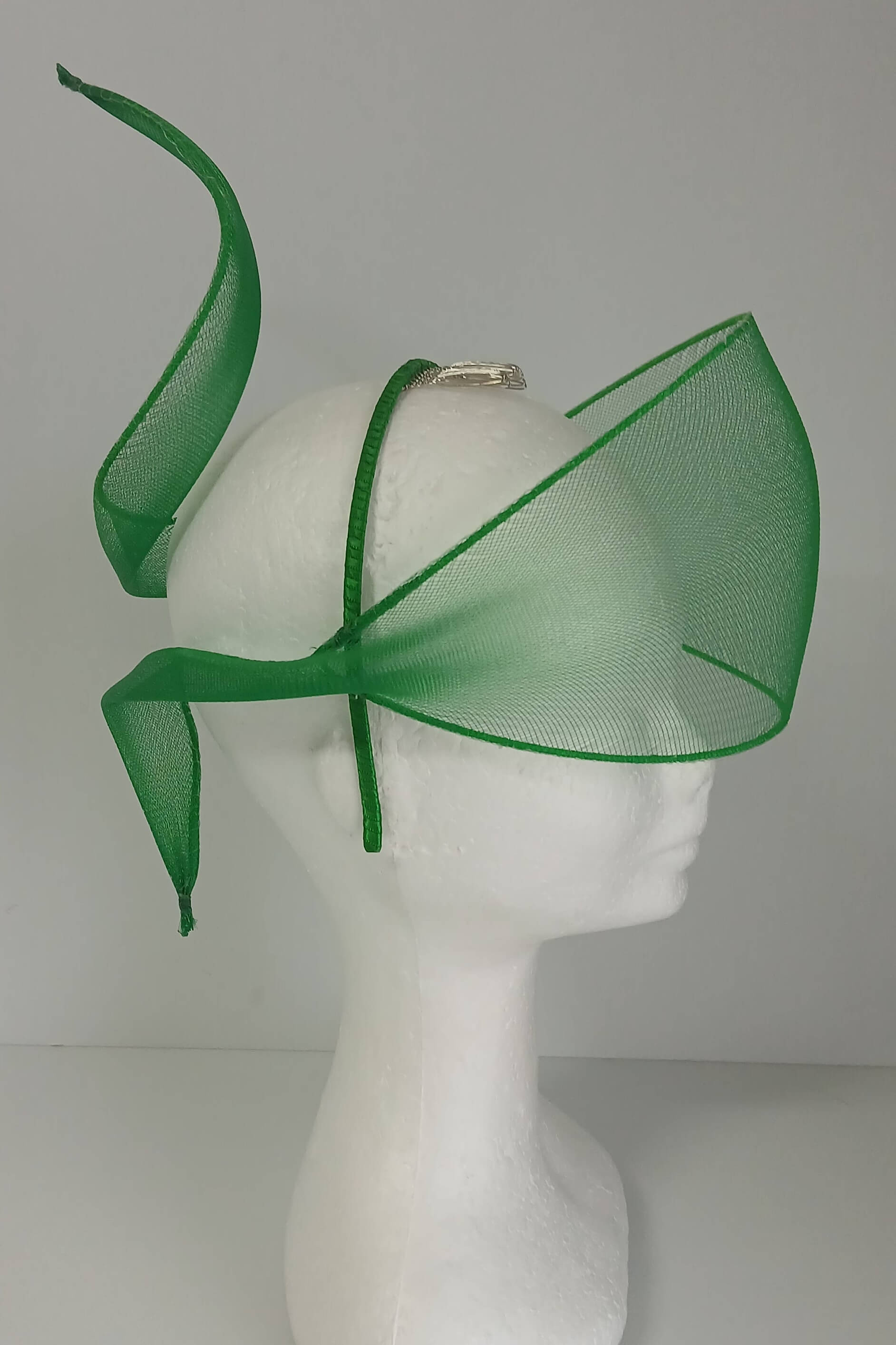 A picture of a green crinoline veil with Swirls by Melissa Rath Millinery