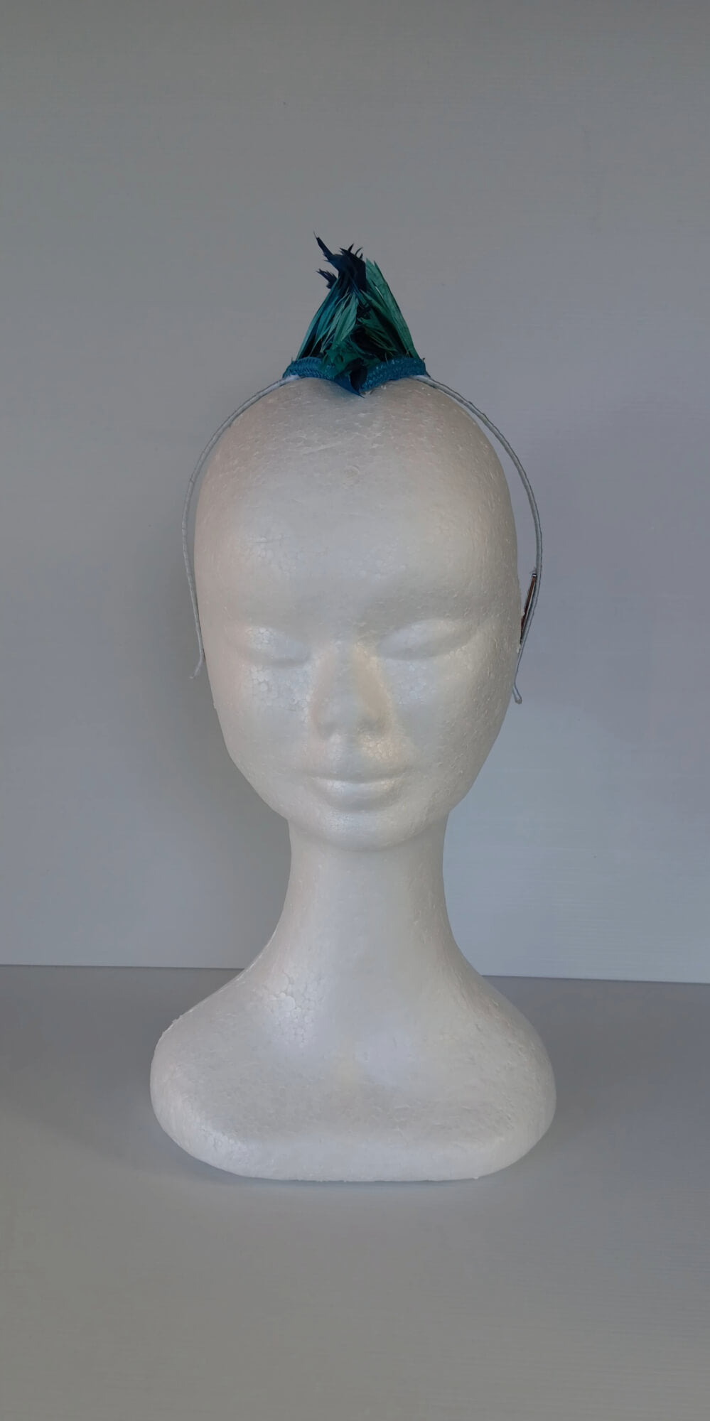 A picture of a Blue and Green Feathered Millinery Mohawk by Melissa Rath Millinery.