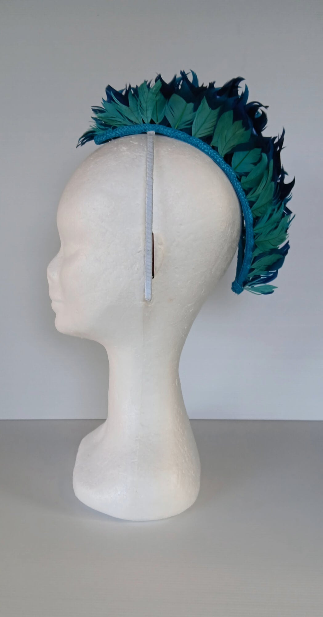 A picture of a Blue and Green Feathered Millinery Mohawk by Melissa Rath Millinery.