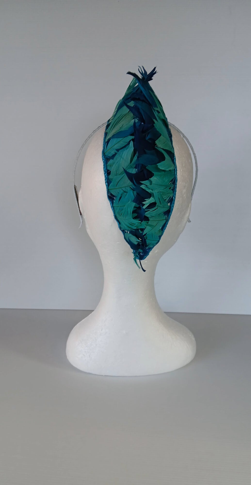 A picture of a Blue and Green Feathered Millinery Mohawk by Melissa Rath Millinery.