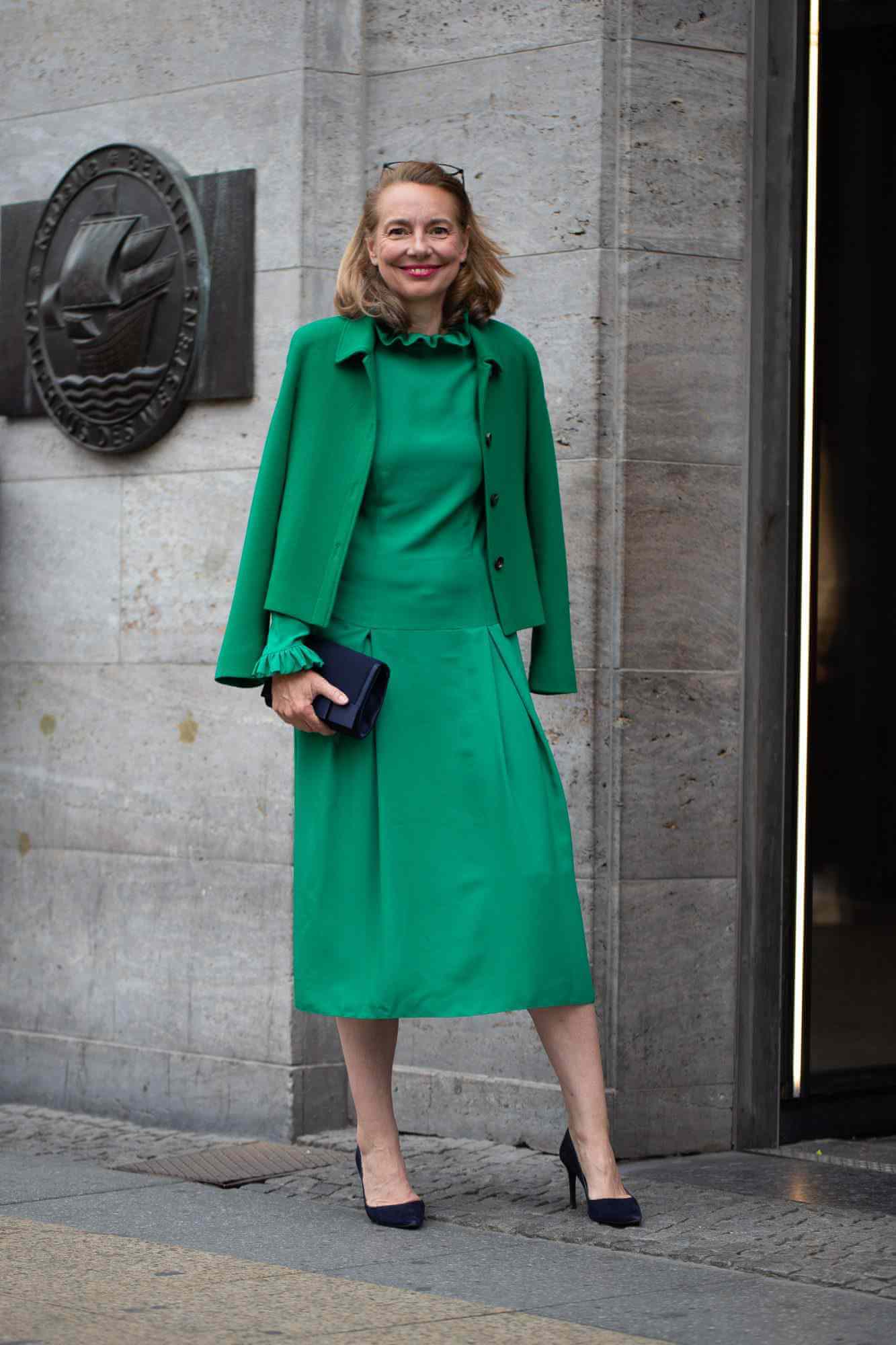 A picture of a woman wearing an outfit in a green monochromatic colour scheme.