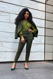 A picture of a woman wearing an outfit in a green monochromatic colour scheme.