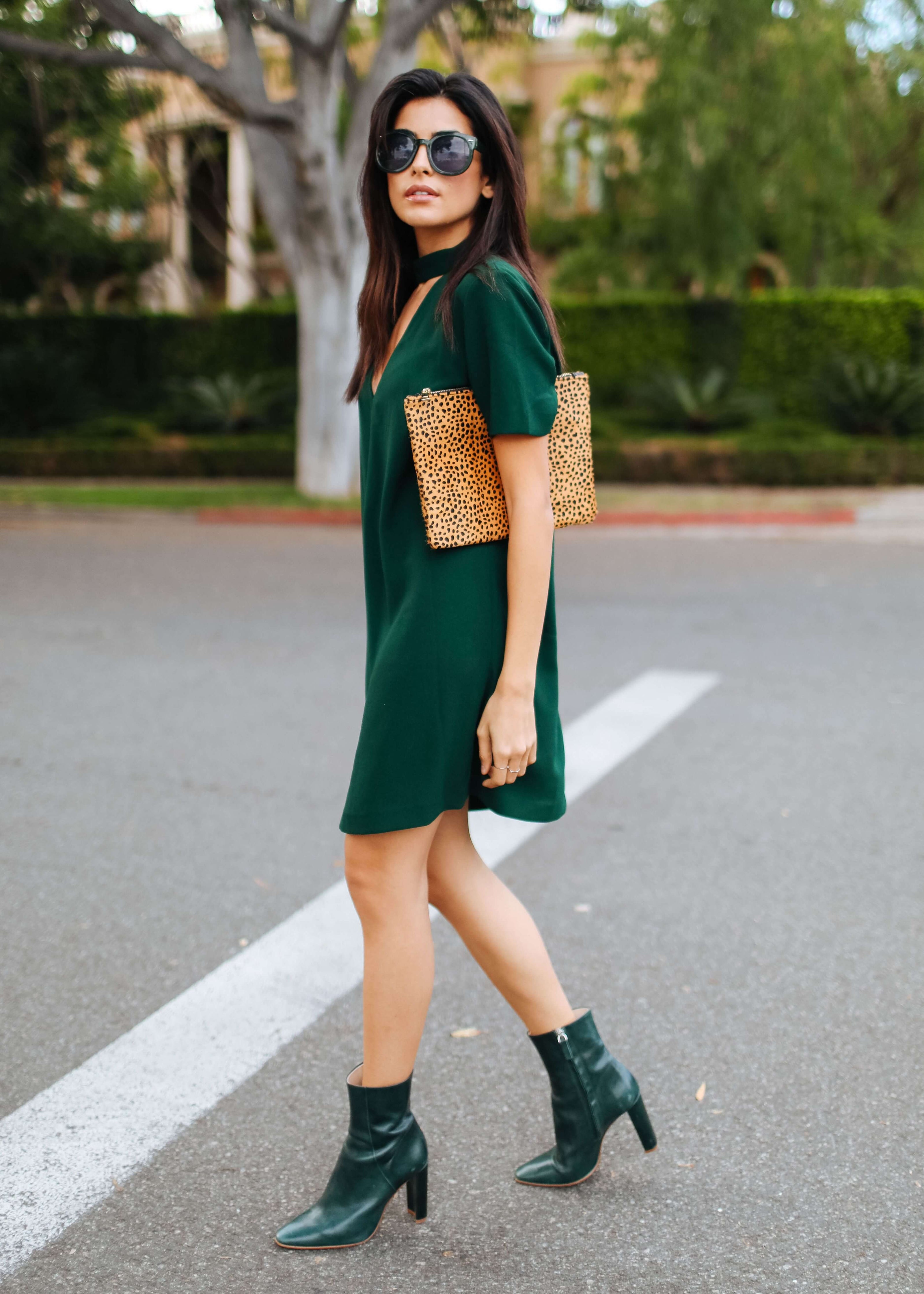A picture of a woman wearing an outfit in a green monochromatic colour scheme.