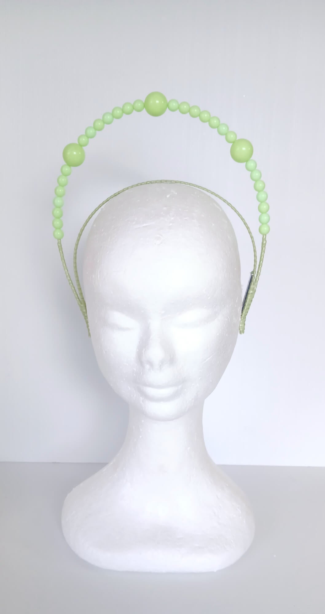 A picture of a Green Beaded Millinery Headband by Melissa Rath Millinery.