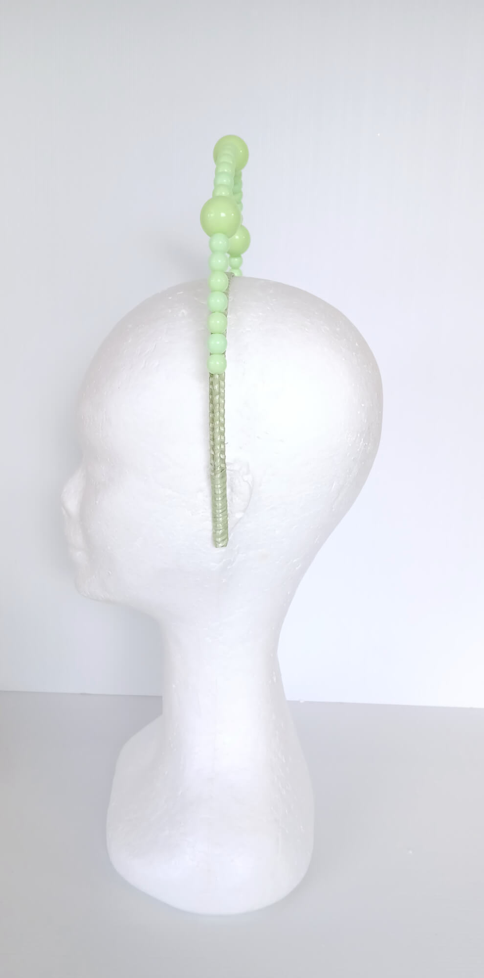 A picture of a Green Beaded Millinery Headband by Melissa Rath Millinery.