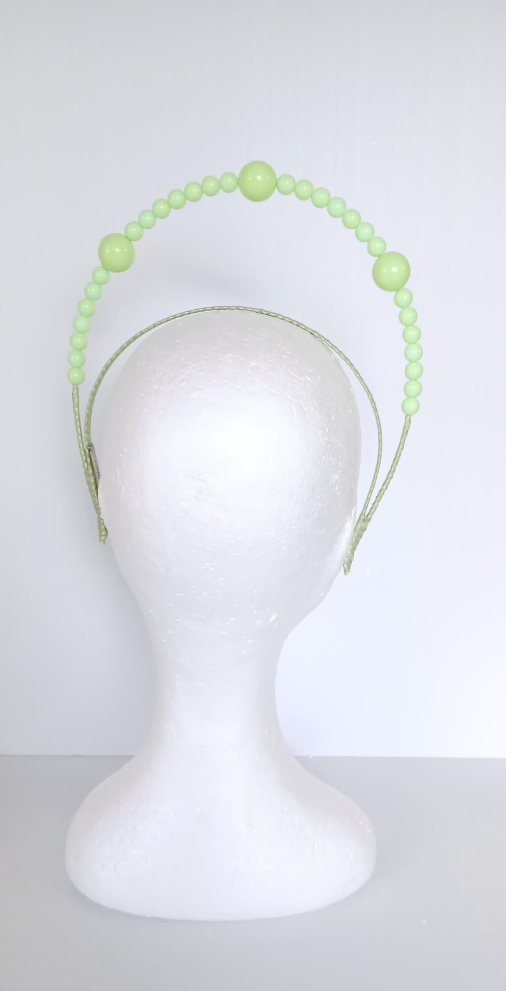 A picture of a Green Beaded Millinery Headband by Melissa Rath Millinery.