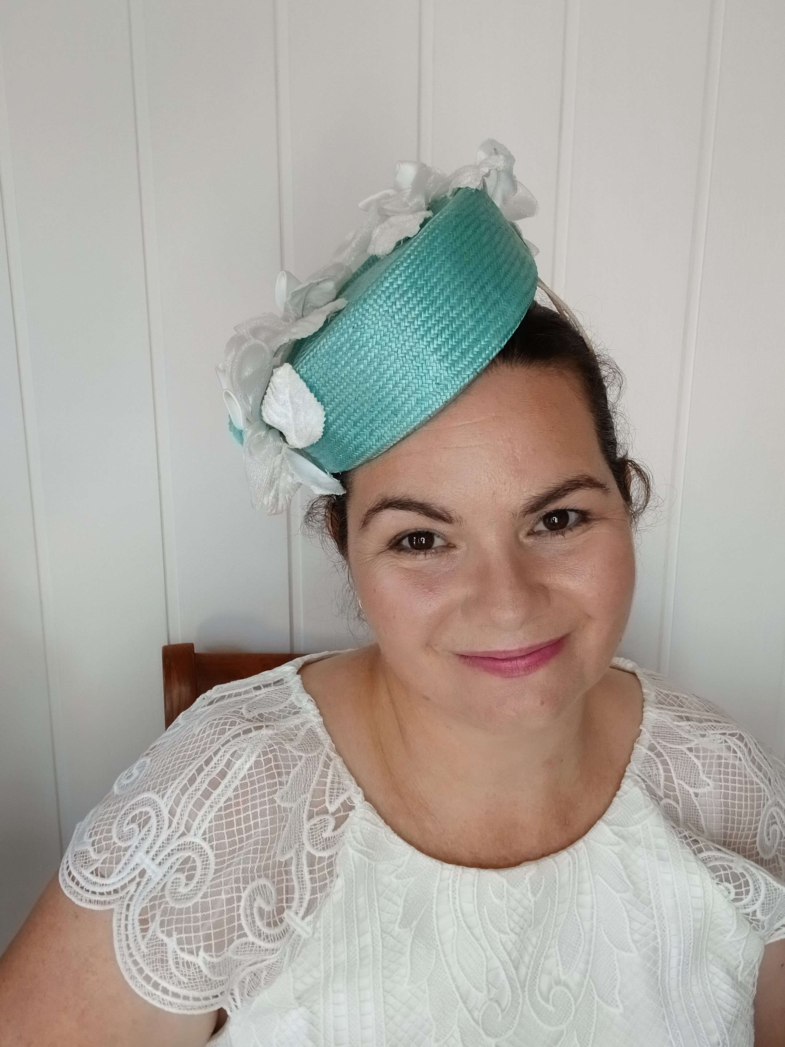 A picture of a Green Millinery Pillbox Hat with white velvet trim by Melissa Rath Millinery.