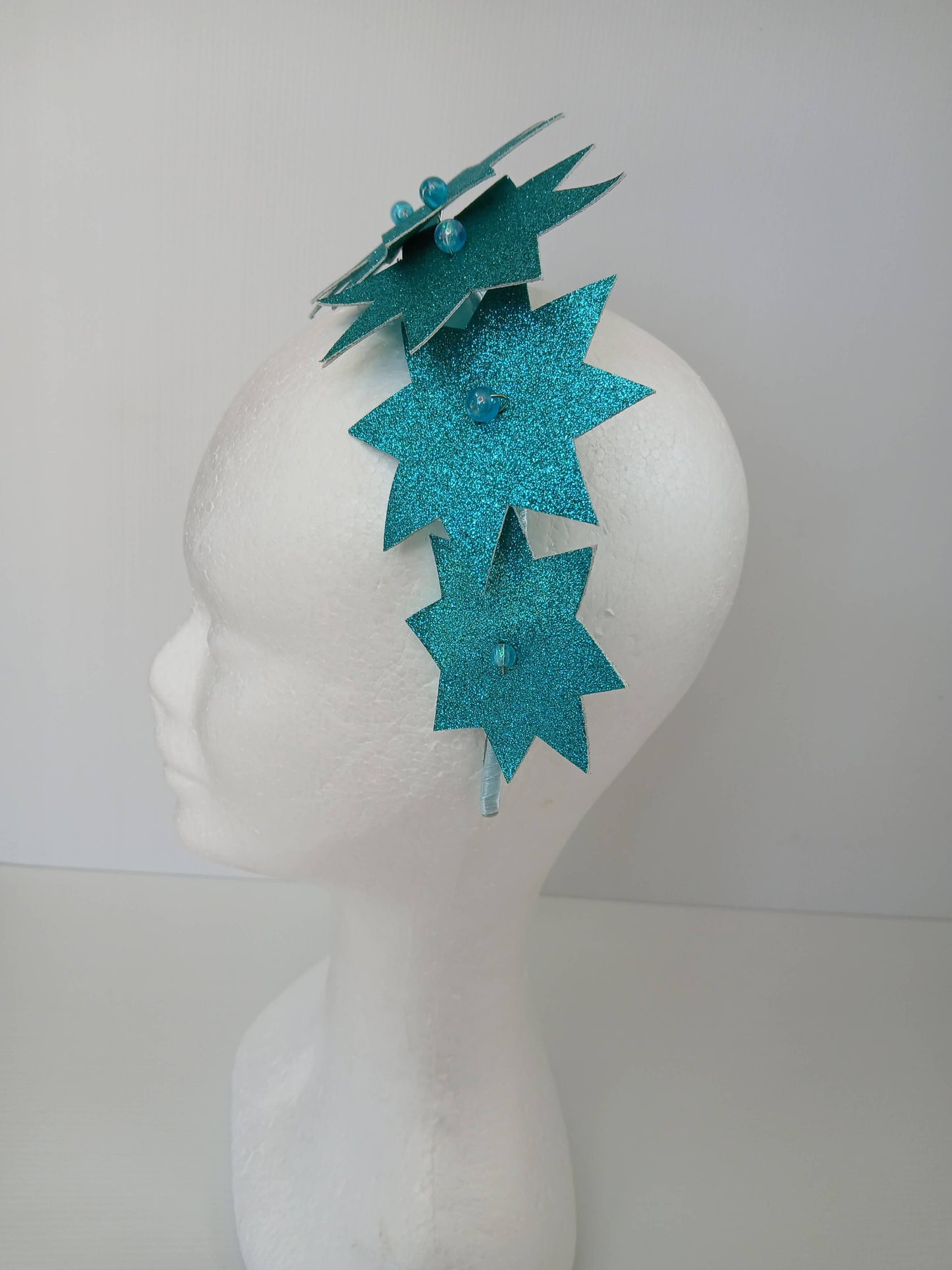 A picture of a Green Pleather Millinery Headband by Melissa Rath Millinery