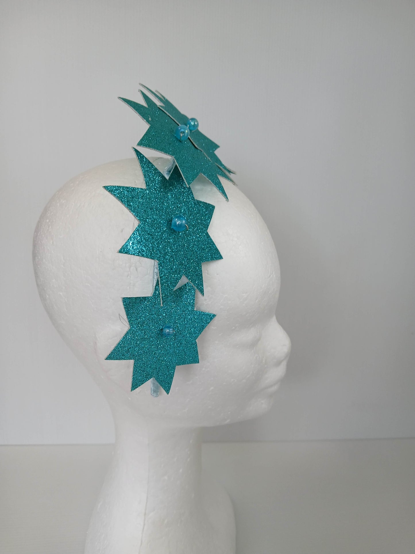 A picture of a Green Pleather Millinery Headband by Melissa Rath Millinery