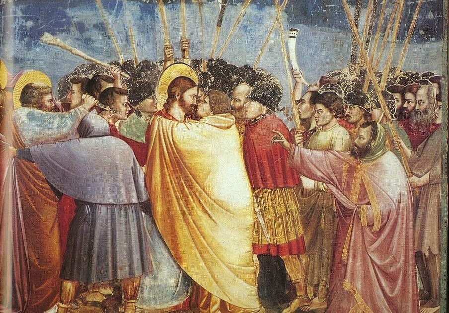 A picture of the "Kiss of Judas" painting from the 12th Century depicting Judas in a yellow robe to show his "true colours"