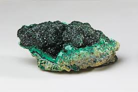 A picture of malachite, a copper-based mineral with vivid bluish-green hues, which was the primary green pigment used in tomb paintings and amulets in Ancient Egypt.