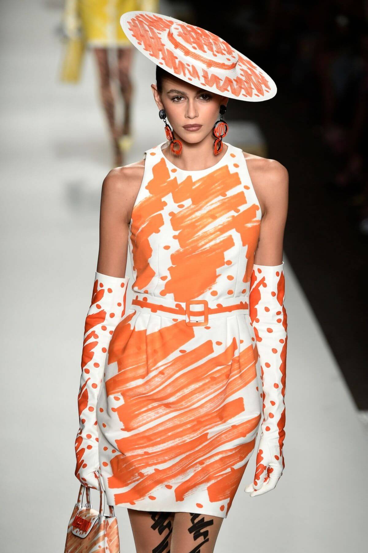 A picture of a model on the catwalk for Moschino 2019.