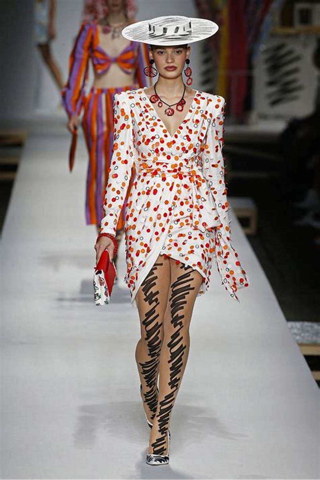 A picture of a model on the catwalk for Moschino 2019.