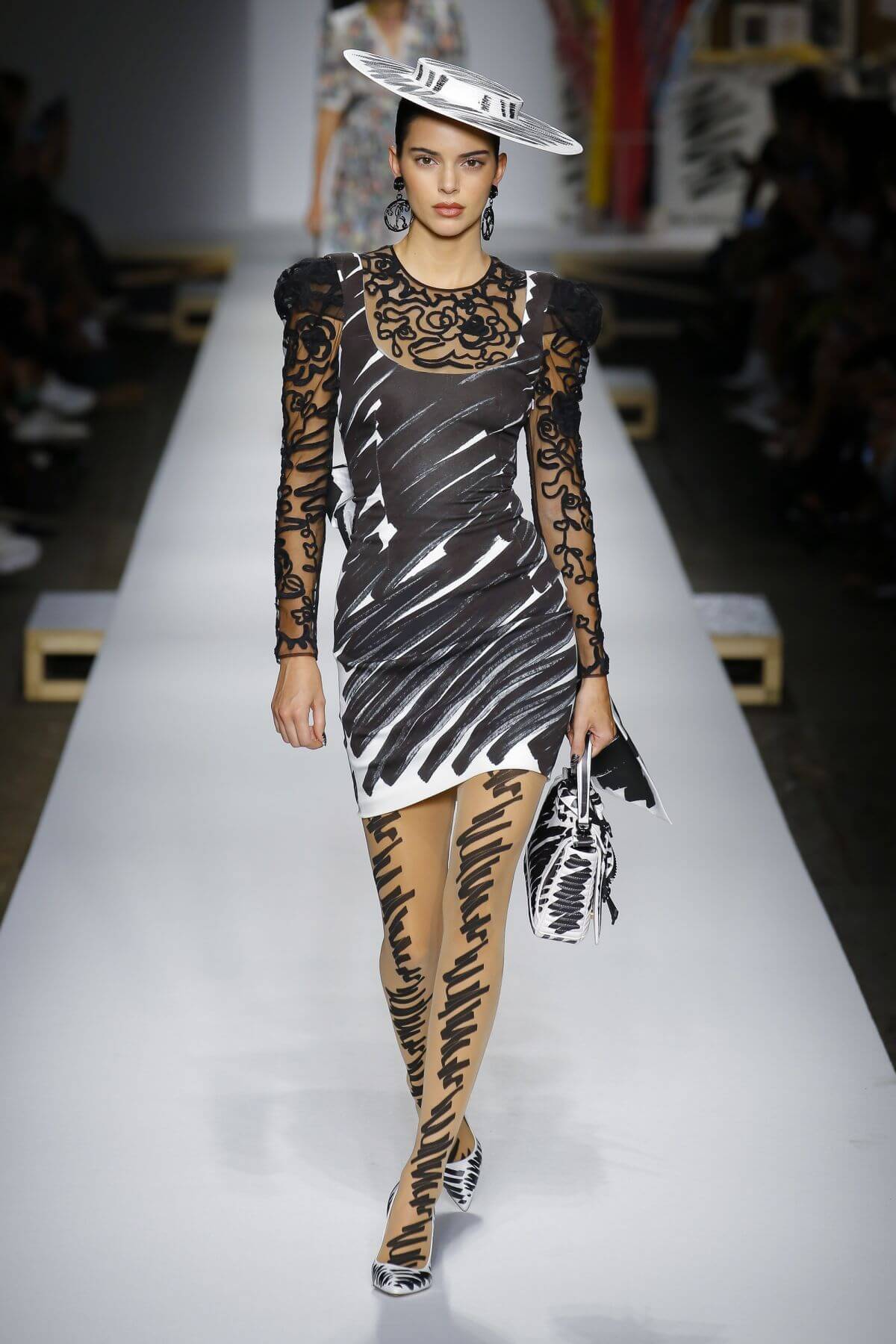 A picture of a model on the catwalk for Moschino 2019.
