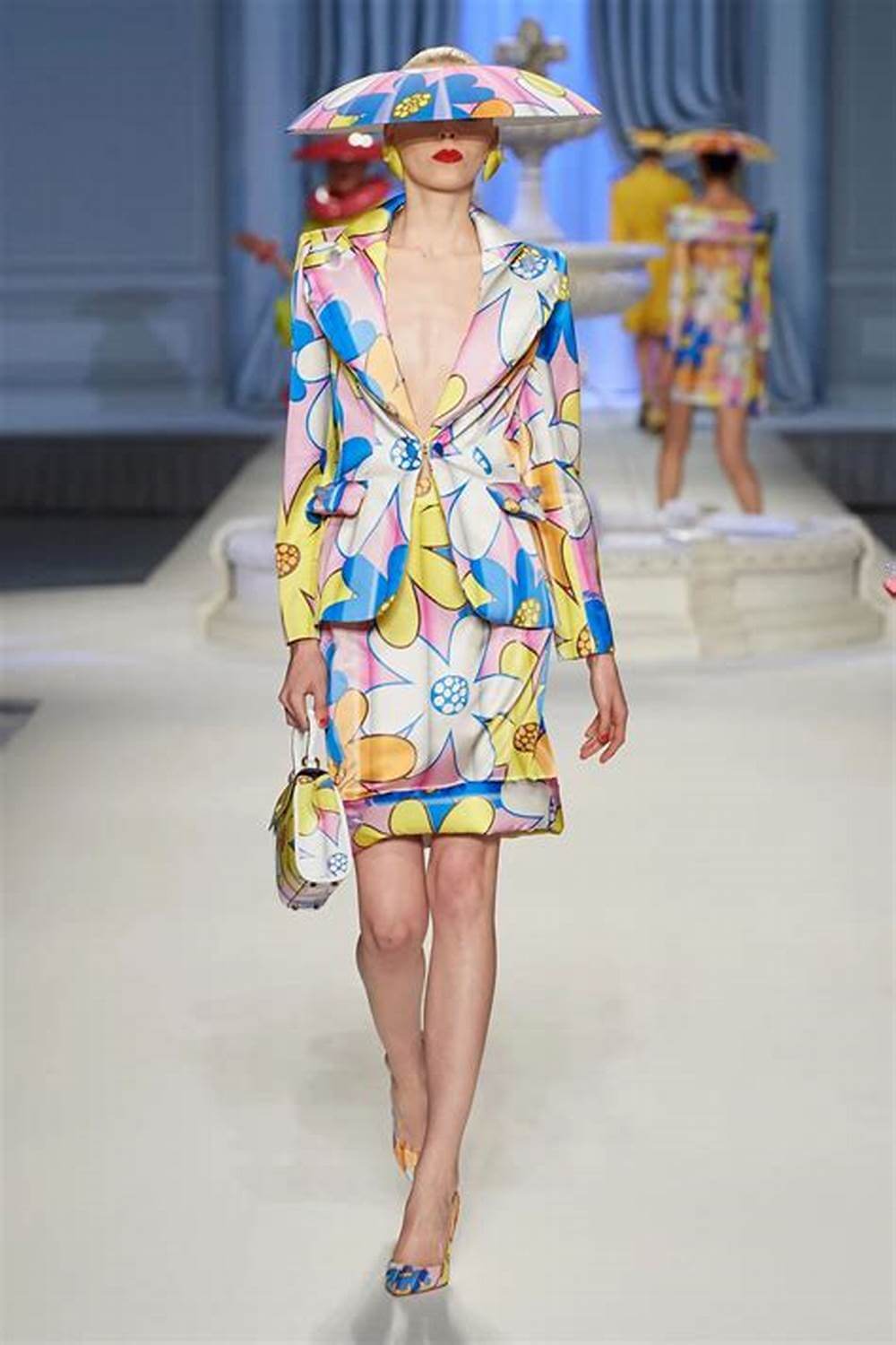 A picture of a model on the catwalk for Moschino 2023.