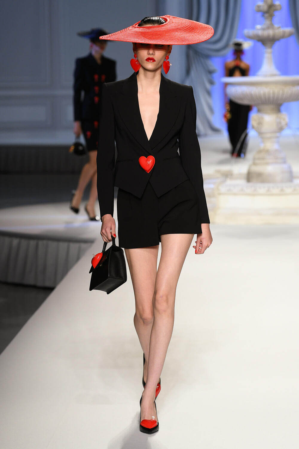 A picture of a model on the catwalk for Moschino 2023.