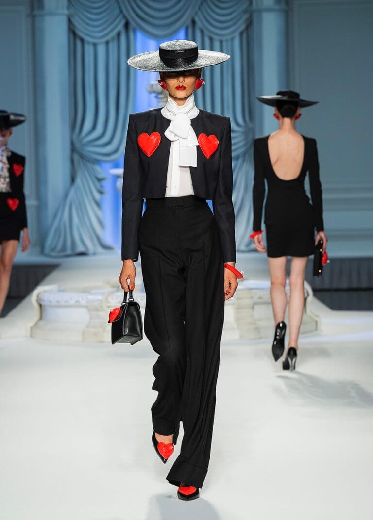 A picture of a model on the catwalk for Moschino 2023.