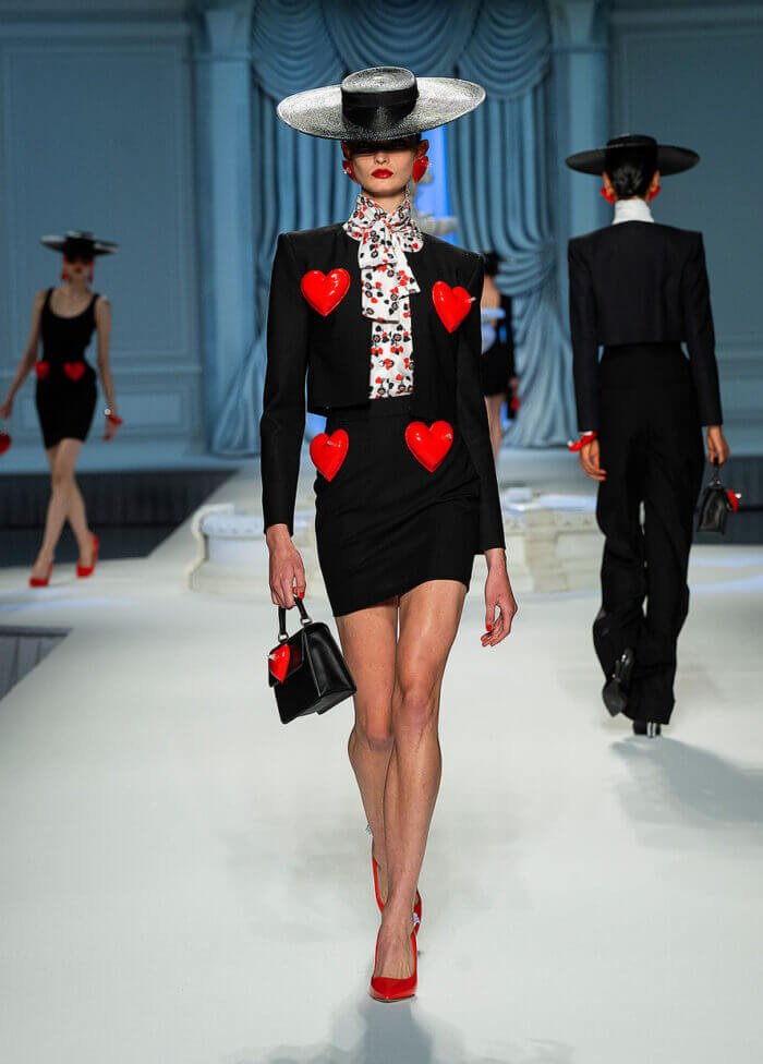 A picture of a model on the catwalk for Moschino 2023.