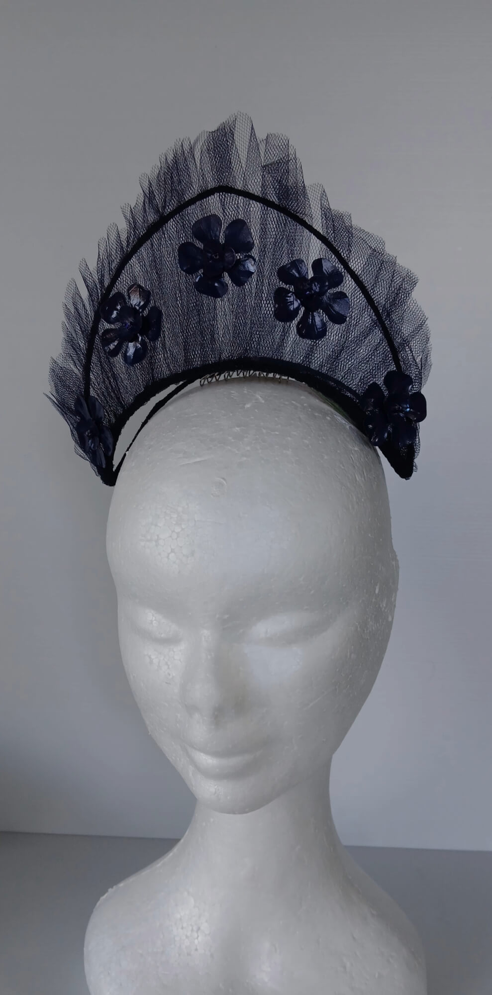 A picture of a Navy Tulle Crown by Melissa Rath Millinery .