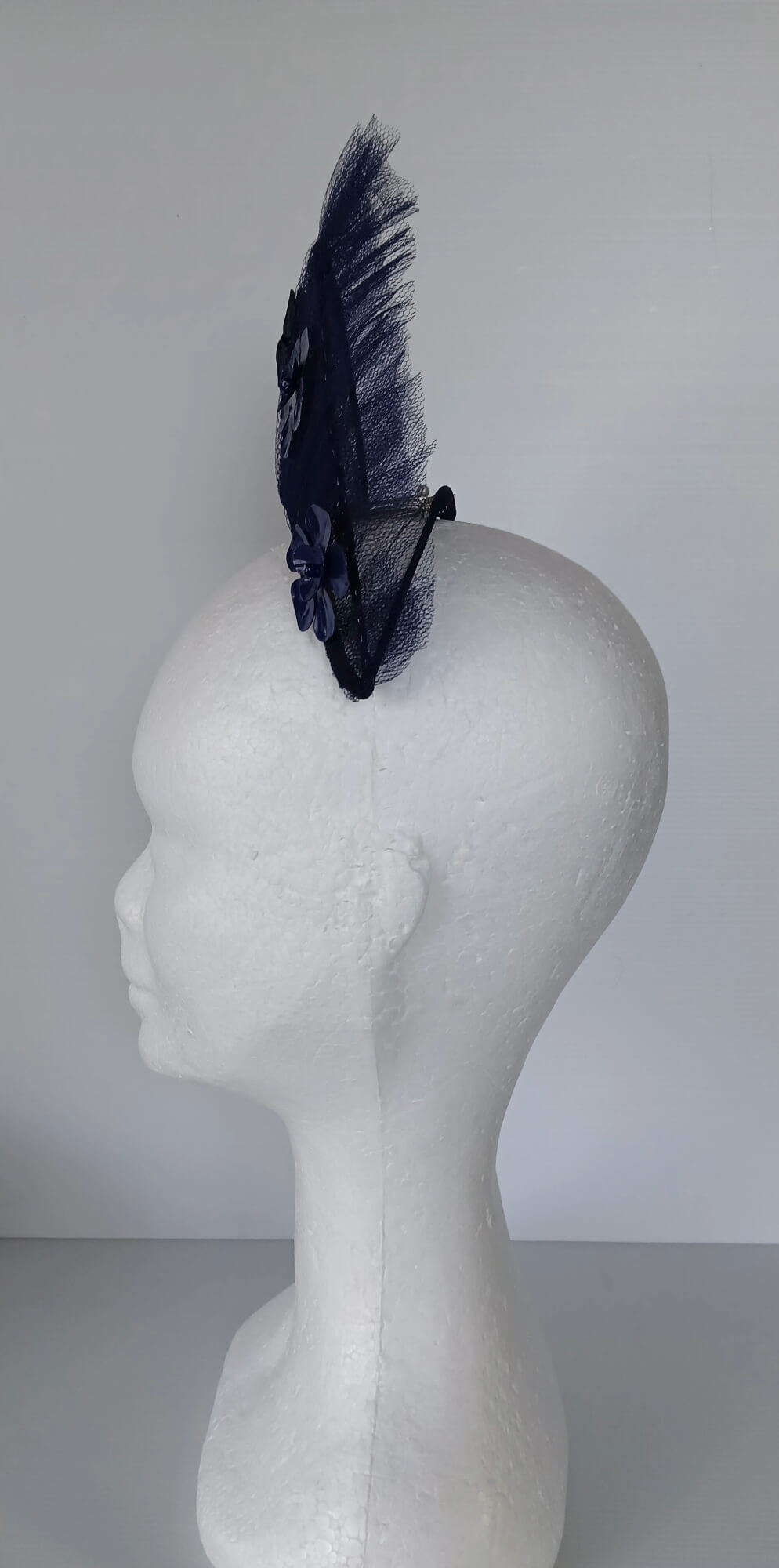 A picture of a Navy Tulle Crown by Melissa Rath Millinery .