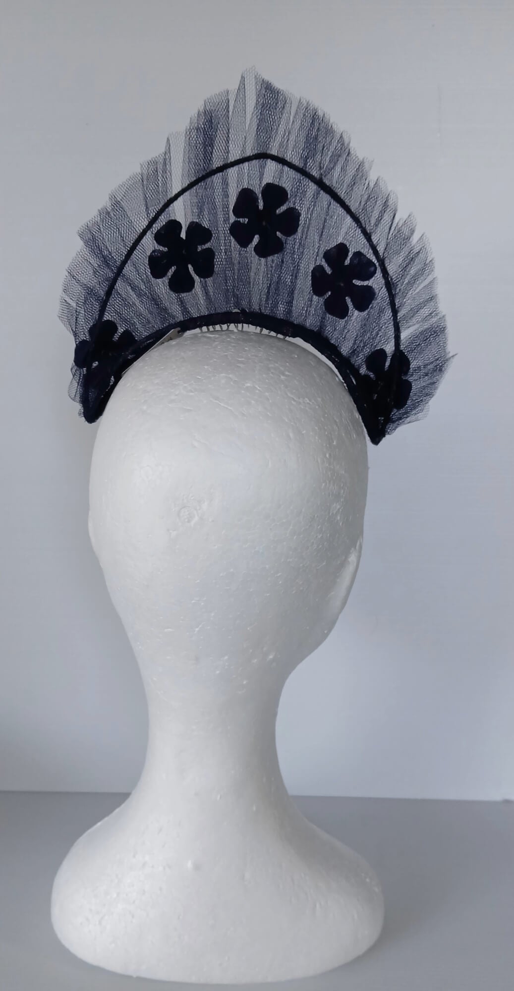 A picture of a Navy Tulle Crown by Melissa Rath Millinery .