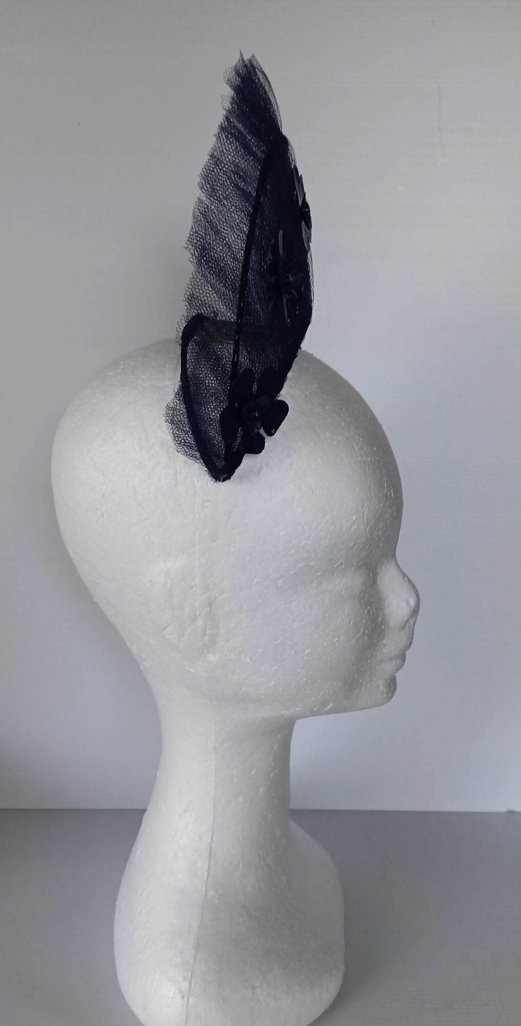 A picture of a Navy Tulle Crown by Melissa Rath Millinery .