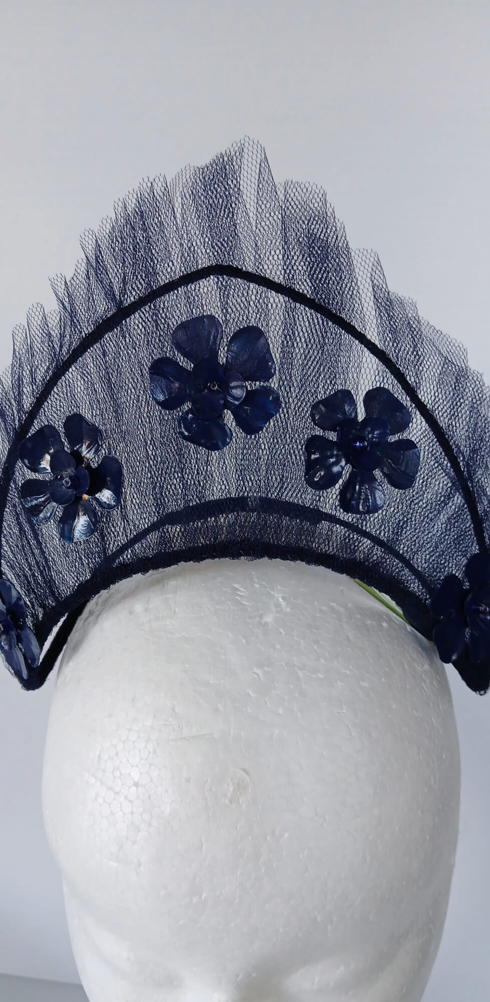 A picture of a Navy Tulle Crown by Melissa Rath Millinery .