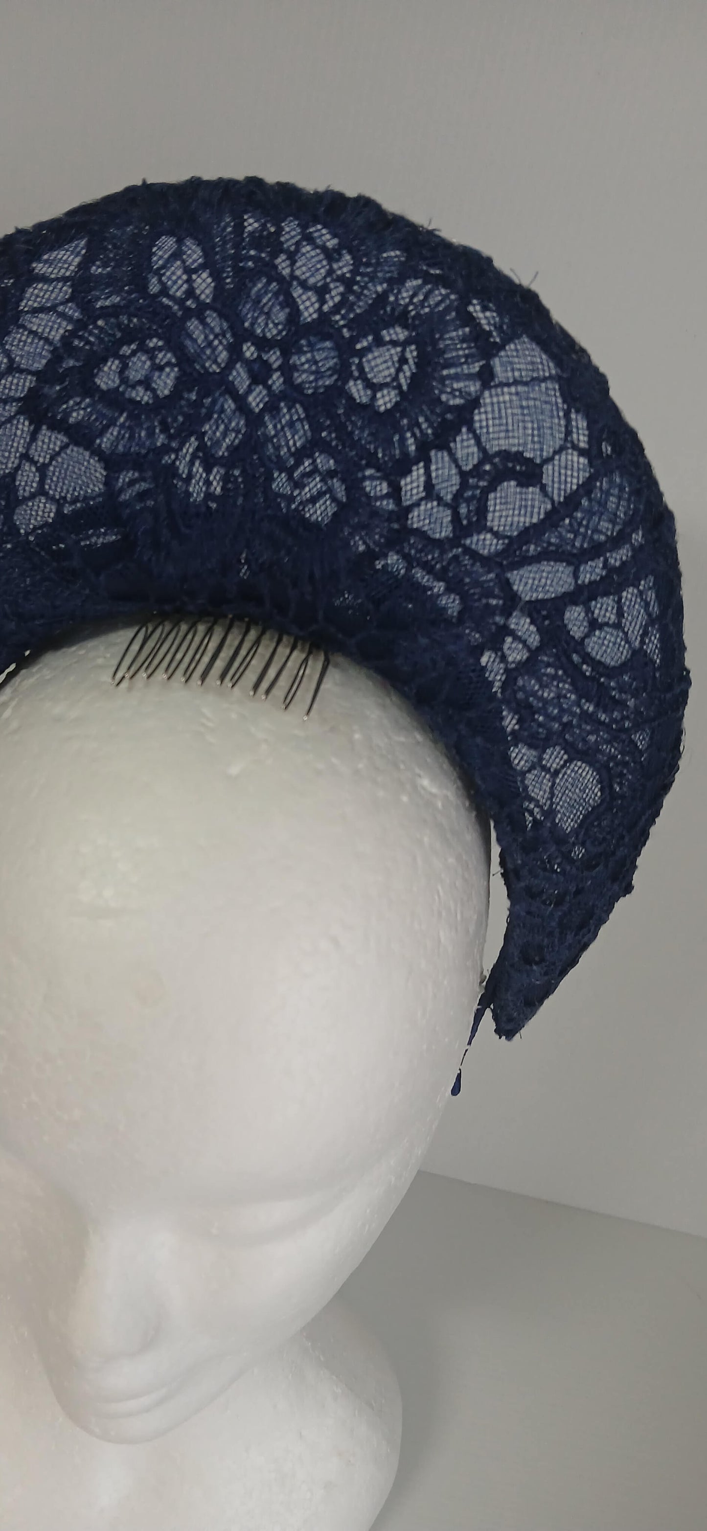 A navy millinery crown by Melissa Rath Millinery, made from crinoline and with a lace overlay.