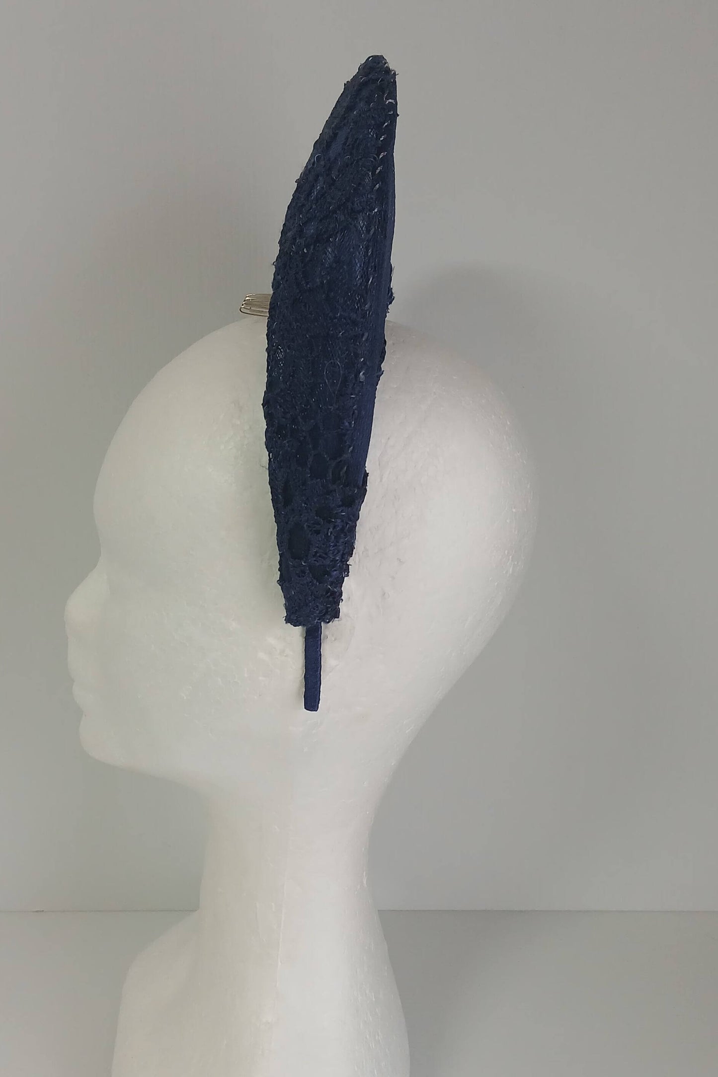 A navy millinery crown by Melissa Rath Millinery, made from crinoline and with a lace overlay.