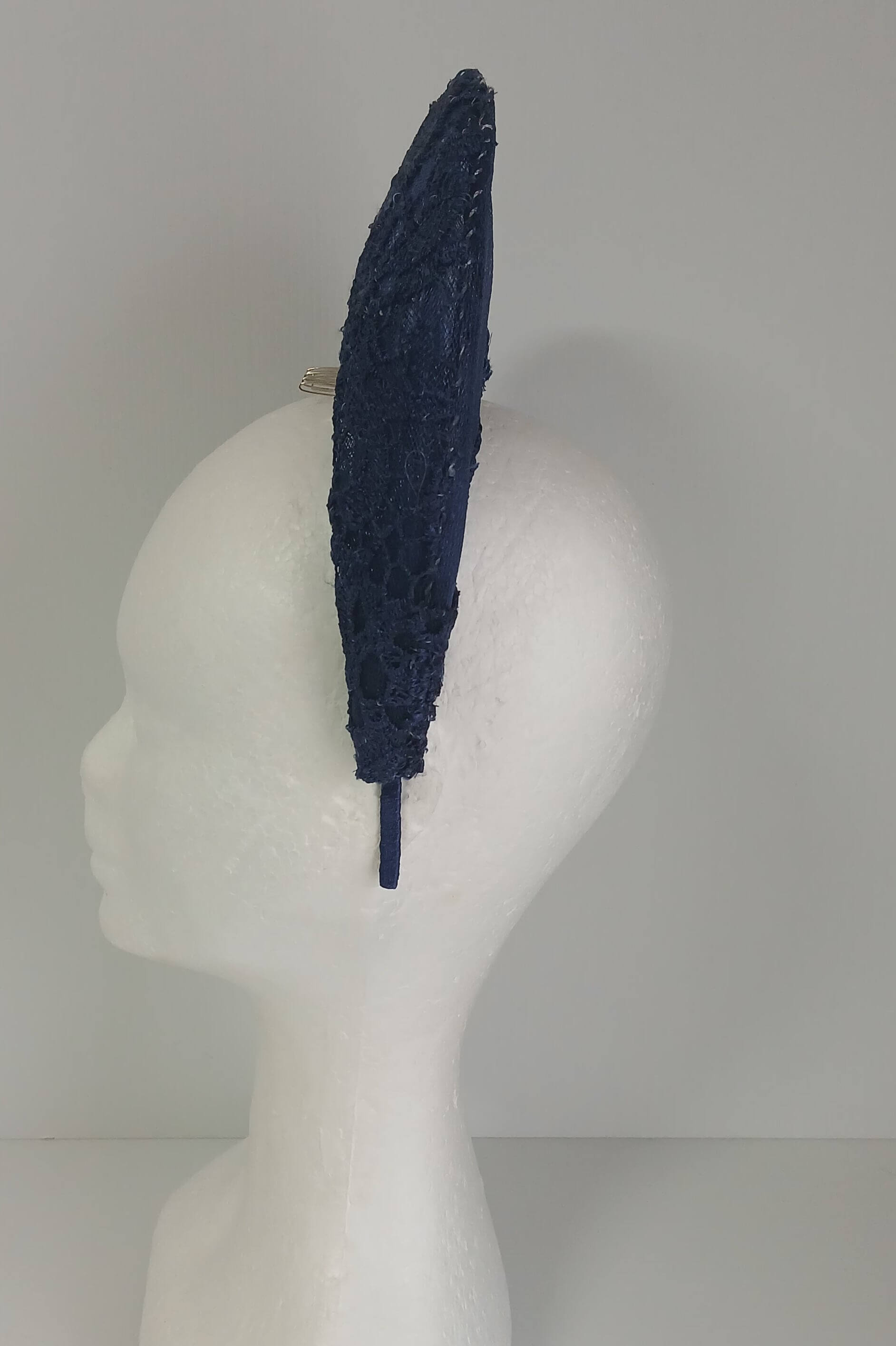 A navy millinery crown by Melissa Rath Millinery, made from crinoline and with a lace overlay.