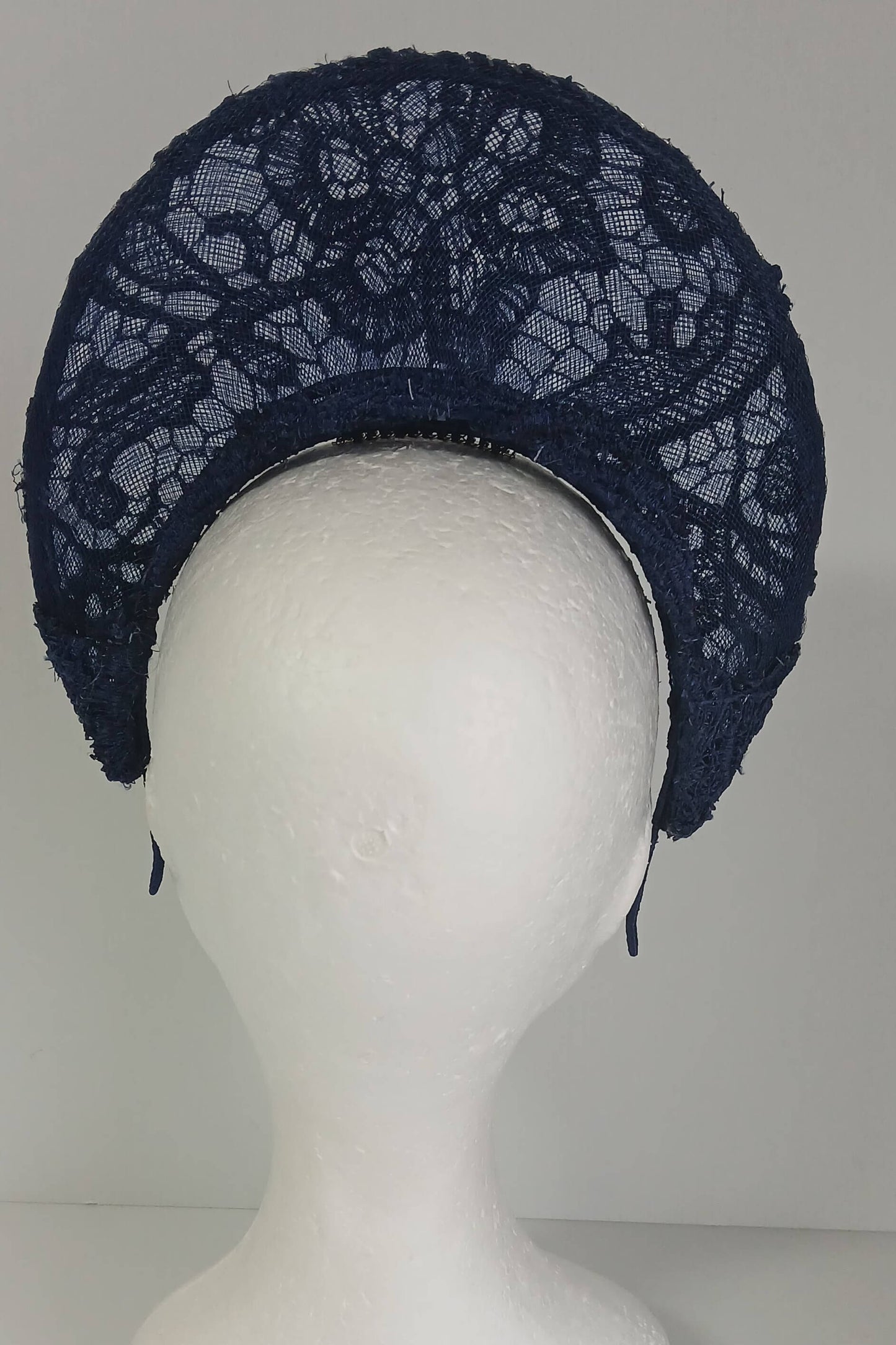 A navy millinery crown by Melissa Rath Millinery, made from crinoline and with a lace overlay.