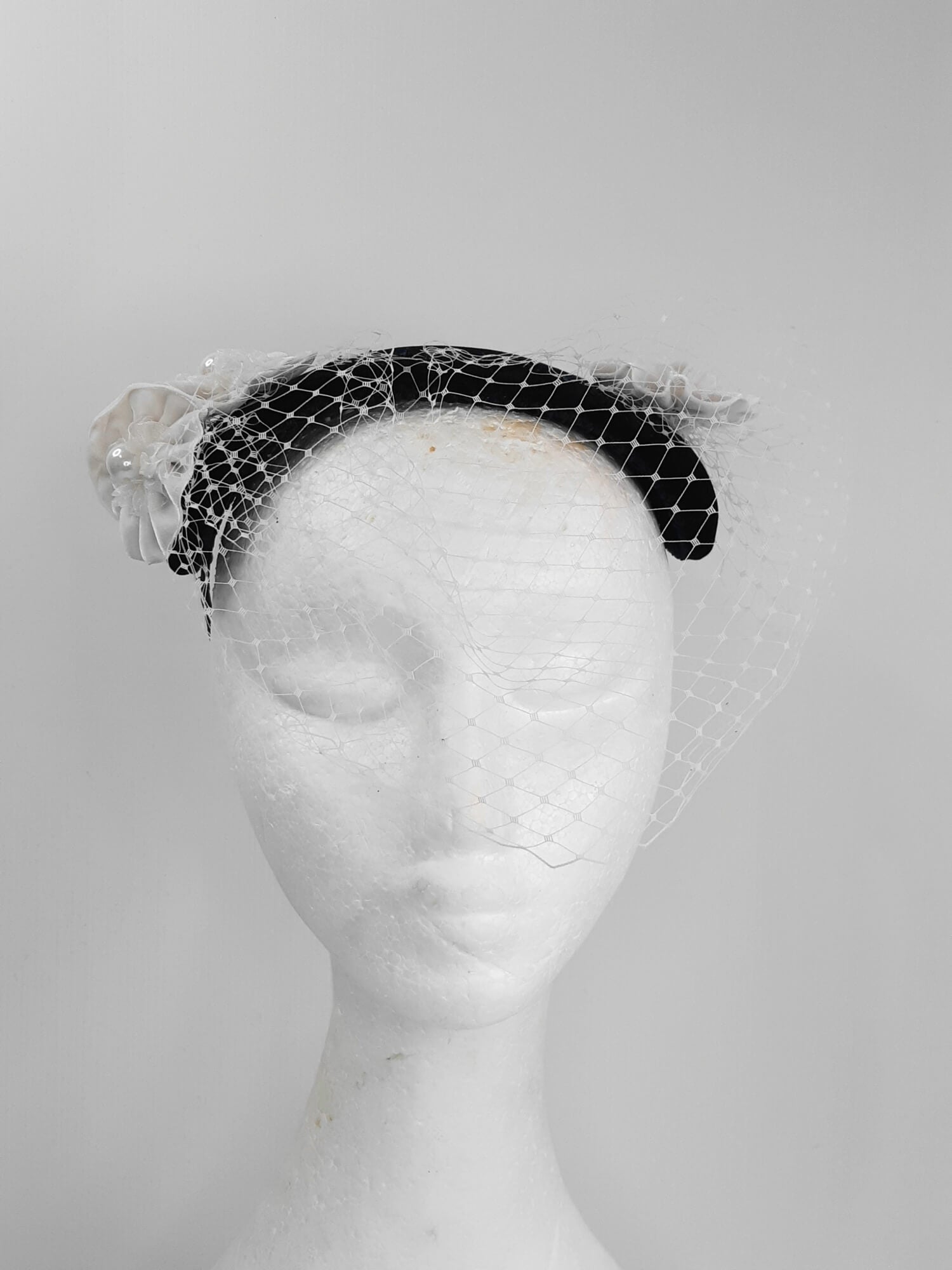 A picture of a Navy and White Veiled Velvet Millinery Fascinator by Melissa Rath Millinery.