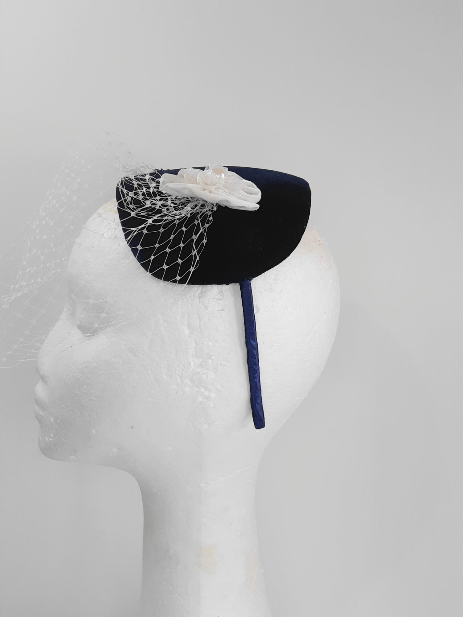 A picture of a Navy and White Veiled Velvet Millinery Fascinator by Melissa Rath Millinery.