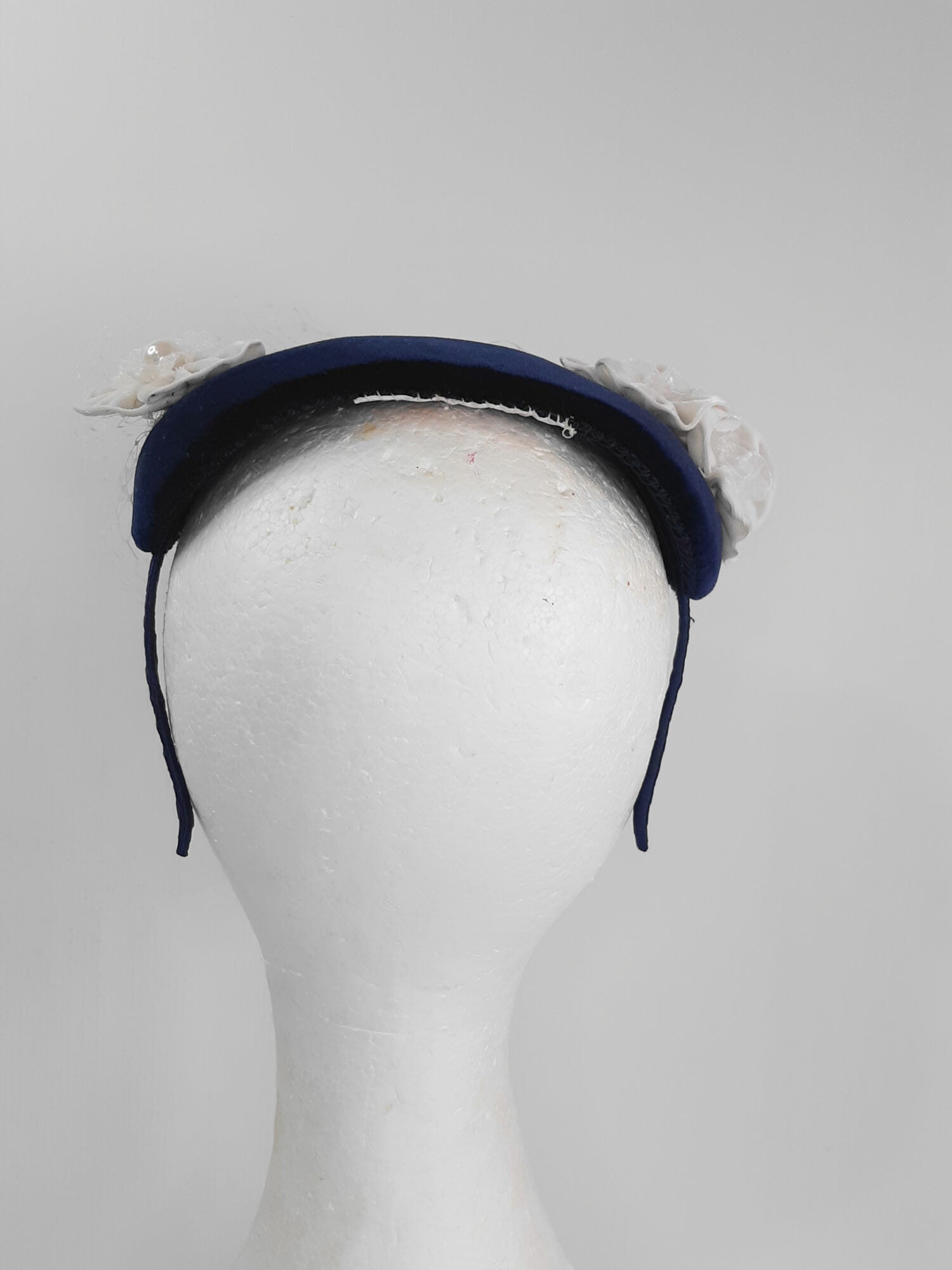 A picture of a Navy and White Veiled Velvet Millinery Fascinator by Melissa Rath Millinery.