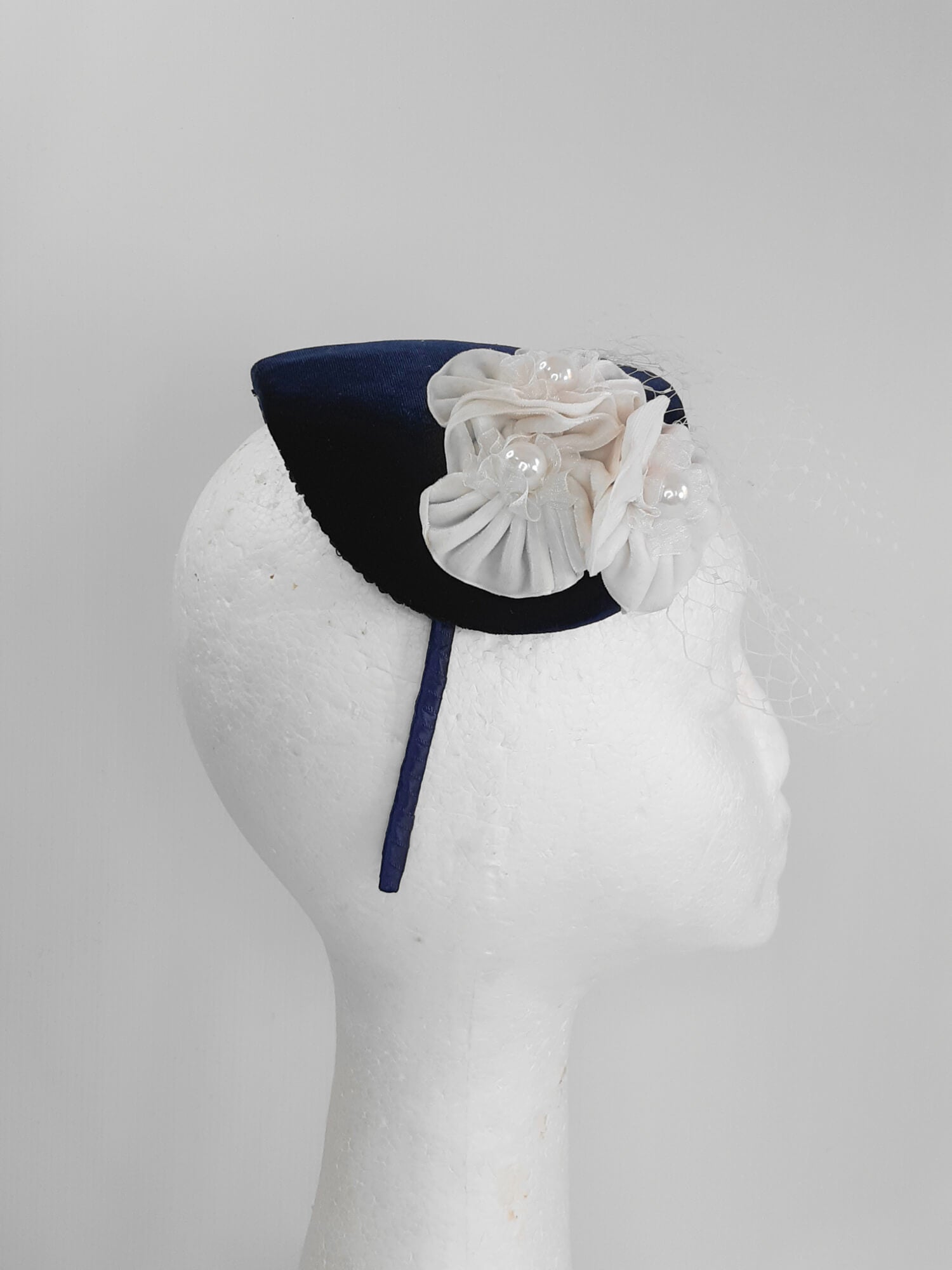 A picture of a Navy and White Veiled Velvet Millinery Fascinator by Melissa Rath Millinery.