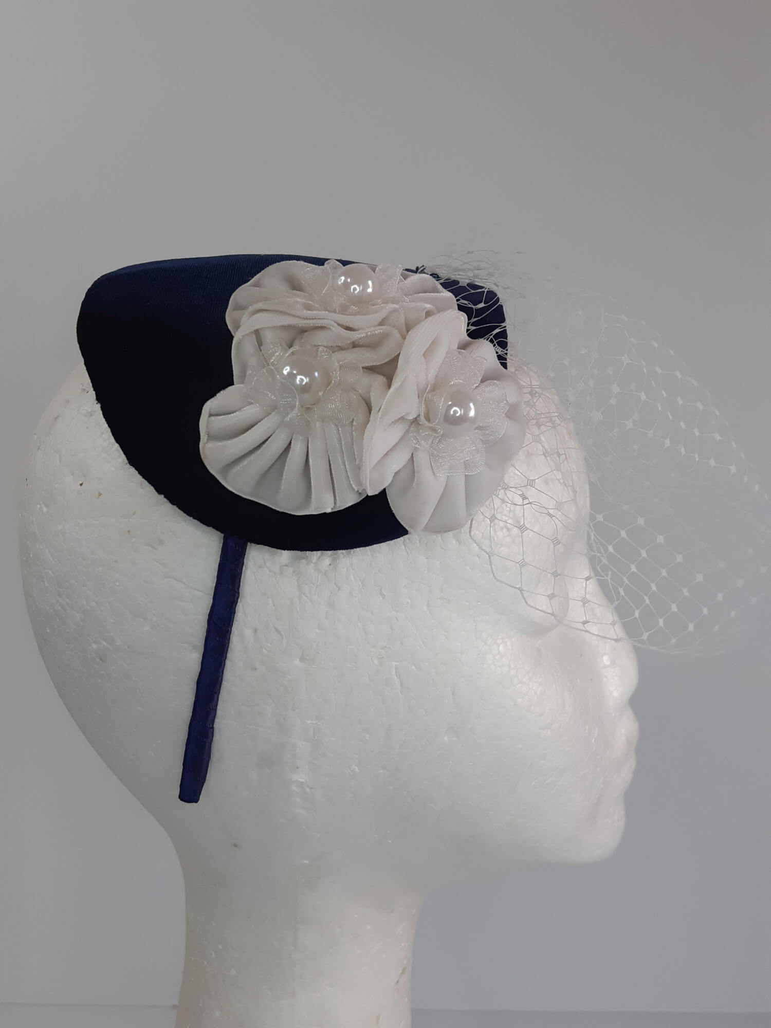 A picture of a Navy and White Veiled Velvet Millinery Fascinator by Melissa Rath Millinery.