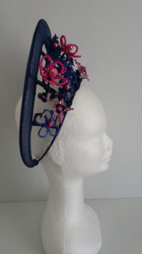 A picture of a Navy and Pink Beaded Crinoline Crown by Melissa Rath Millinery.