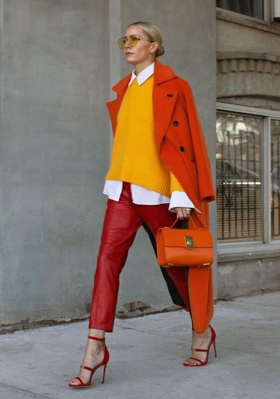 A picture of a woman wearing an outfit in an orange analogous colour scheme.