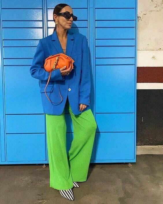 A picture of a woman wearing an outfit in an orange split complementary colour scheme.