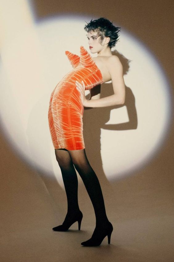 A picture of an orange velvet corset dress made by Jean Paul Gaultier for Madonna